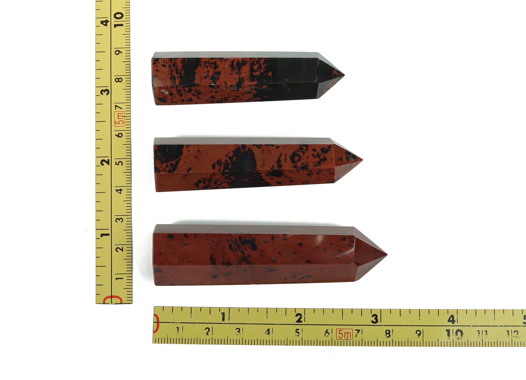 Mahogany Obsidian obelisk tower crystal from GemstoneGO, polished black and reddish-brown stone with natural stone textures.