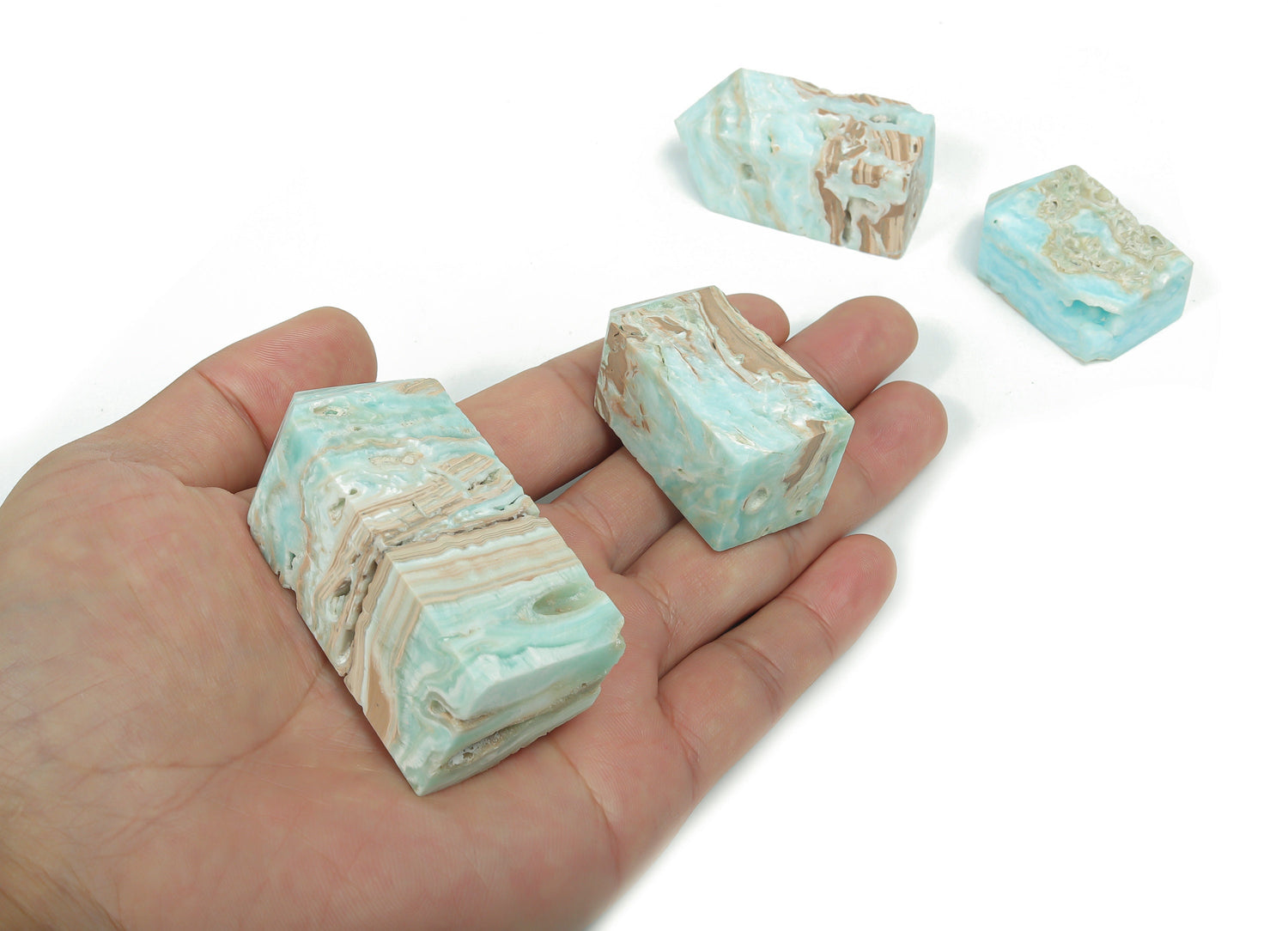Blue Caribbean Calcite Druzy Obelisk Tower crystal from GemstoneGO, showcasing a vibrant blue mineral with sparkling druzy details.