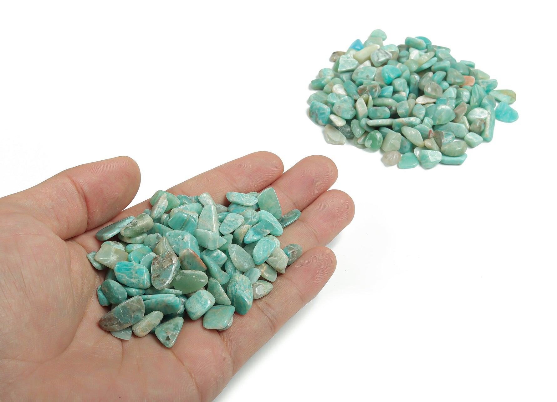 Amazonite crystal chips in 7-12mm semi-tumbled stones, natural gemstone from GemstoneGO, shown in bulk with vibrant blue-green hues.