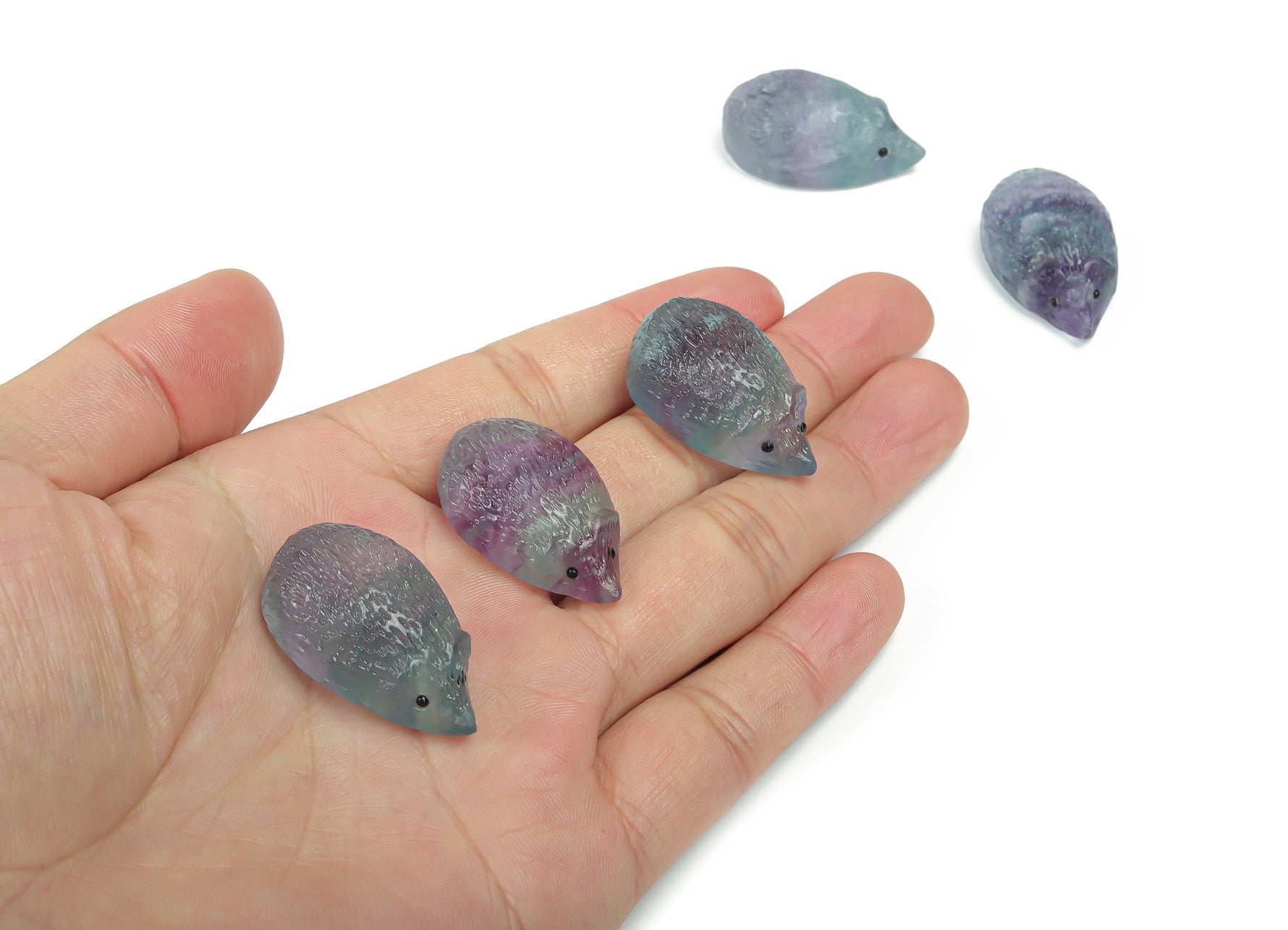 Fluorite hedgehog gemstone carving by GemstoneGO, showcasing vibrant purple and green hues with detailed stone craftsmanship.