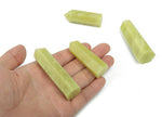 Lemon Jade Obelisk Tower crystal from GemstoneGO, polished yellow-green gemstone with pointed tip and smooth surface.