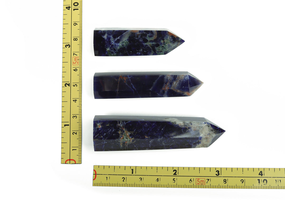 Sodalite obelisk tower crystal from GemstoneGO, featuring deep blue and white mineral patterns, standing upright tall.