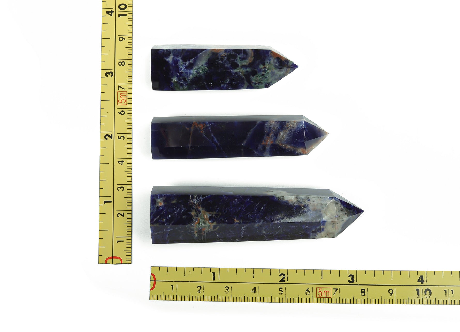 Sodalite obelisk tower crystal from GemstoneGO, featuring deep blue and white mineral patterns, standing upright tall.