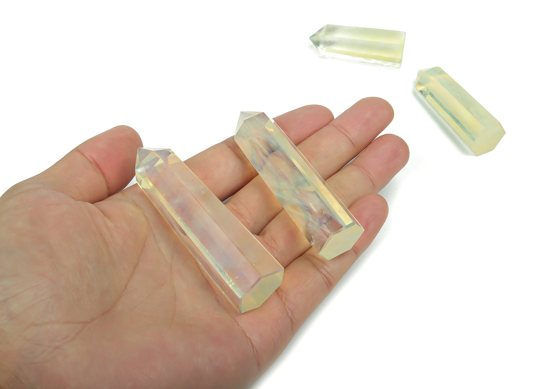 Lemon citrine quartz obelisk tower crystal from GemstoneGO, showcasing a bright yellow gemstone with a pointed top and smooth facets.