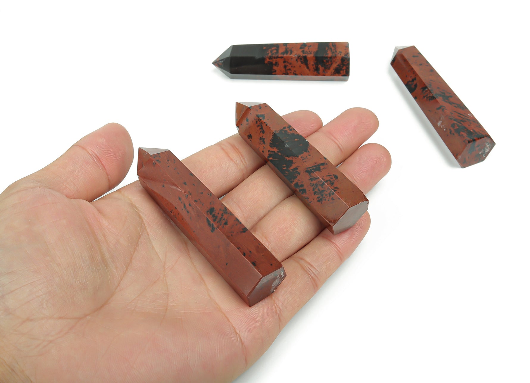 Mahogany Obsidian obelisk tower crystal by GemstoneGO, showcasing a sleek, polished dark brown and black mineral sculpture.