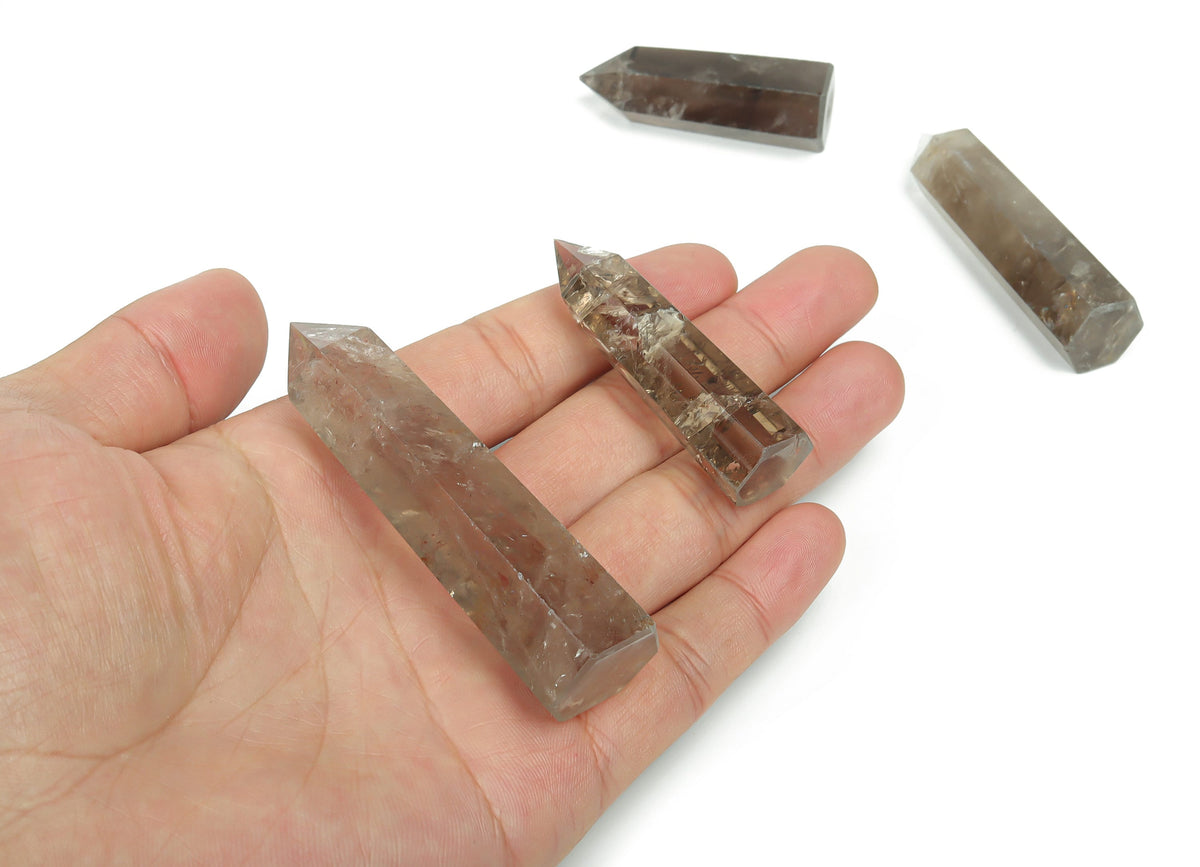 Smoky Quartz obelisk tower crystal from GemstoneGO, showcasing a polished, dark gray gemstone with natural crystal formations.