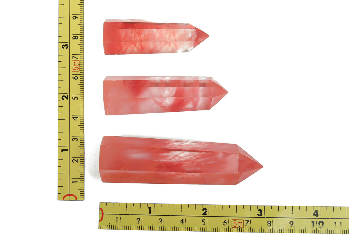 Cherry quartz obelisk tower crystal from GemstoneGO, showcasing a vibrant red gemstone with a pointed, polished crystal structure.