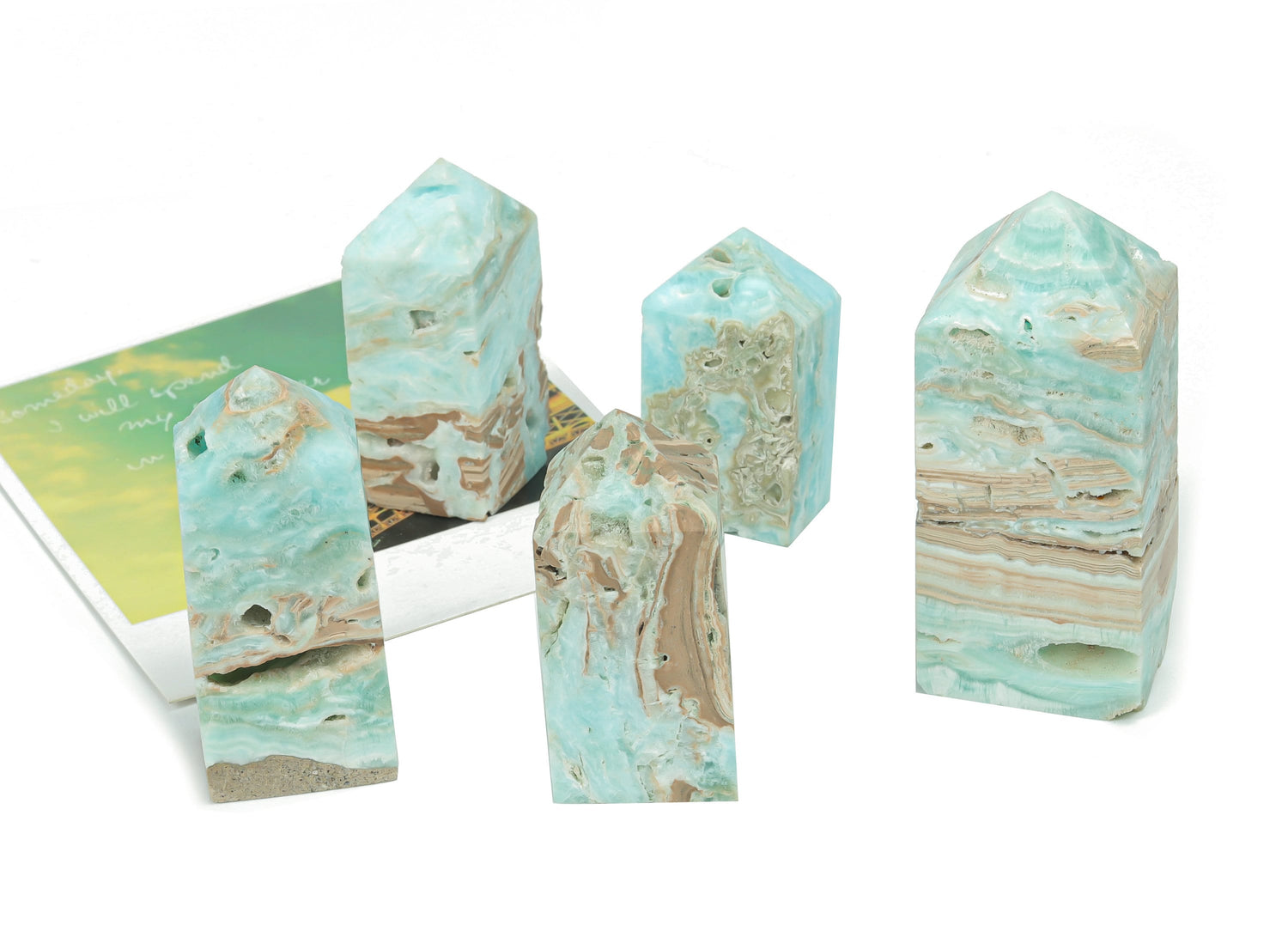 Blue Caribbean Calcite Druzy Obelisk Tower crystal from GemstoneGO featuring a polished blue and white mineral display
