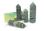Green Zebra Calcite obelisk tower crystal from GemstoneGO, featuring vibrant green and white striped mineral formations.
