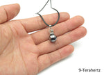 Terahertz crystal cord necklace featuring a healing gemstone, showcasing a polished gemstone pendant on a black cord.
