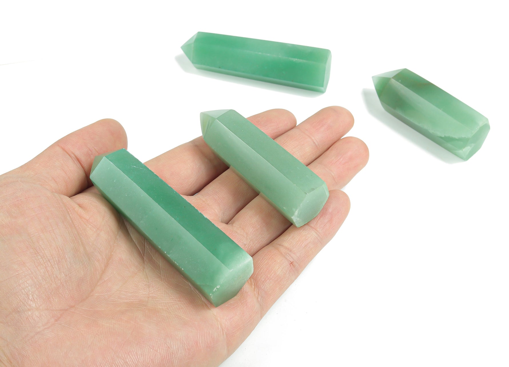 Aventurine obelisk tower crystal from GemstoneGO with green stone and polished pointed shape, showcasing smooth surface and natural texture.