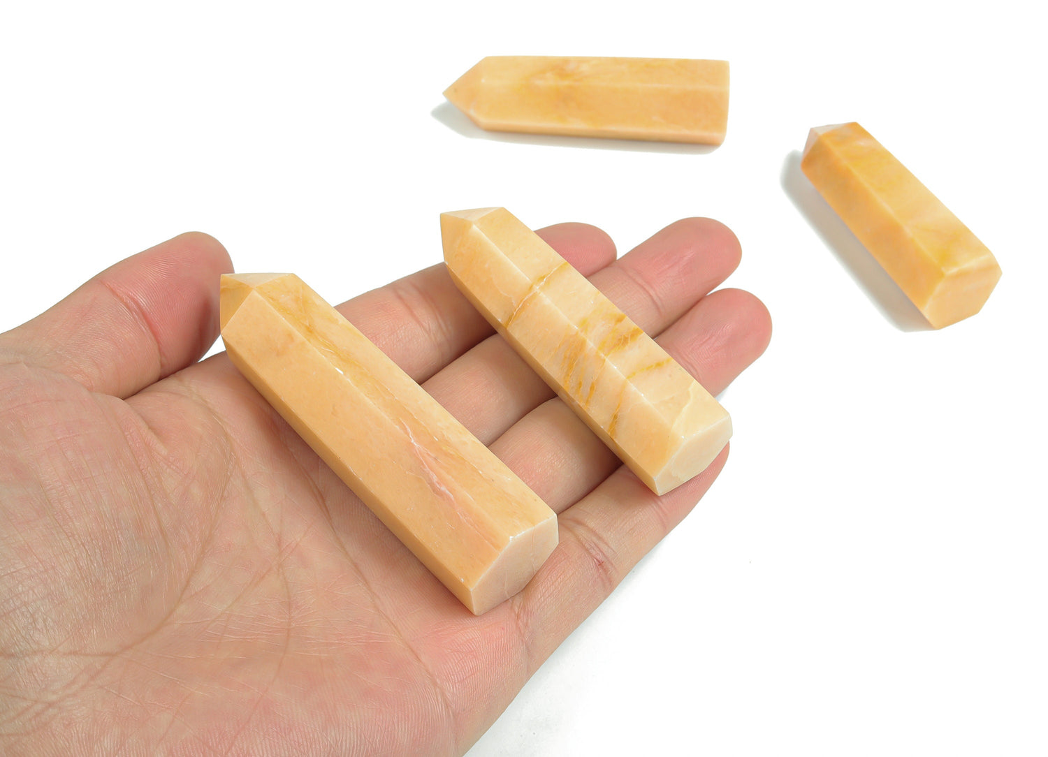 Yellow aventurine obelisk tower crystal from GemstoneGO, showing a smooth, polished yellow gemstone with a pointed obelisk shape.