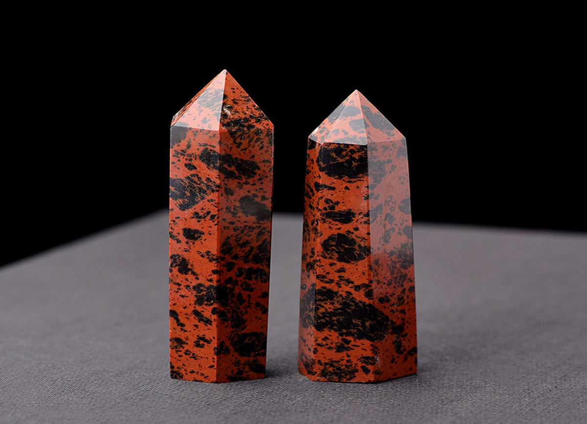 Mahogany Obsidian obelisk tower crystal from GemstoneGO, polished black and reddish-brown stone with natural texture.