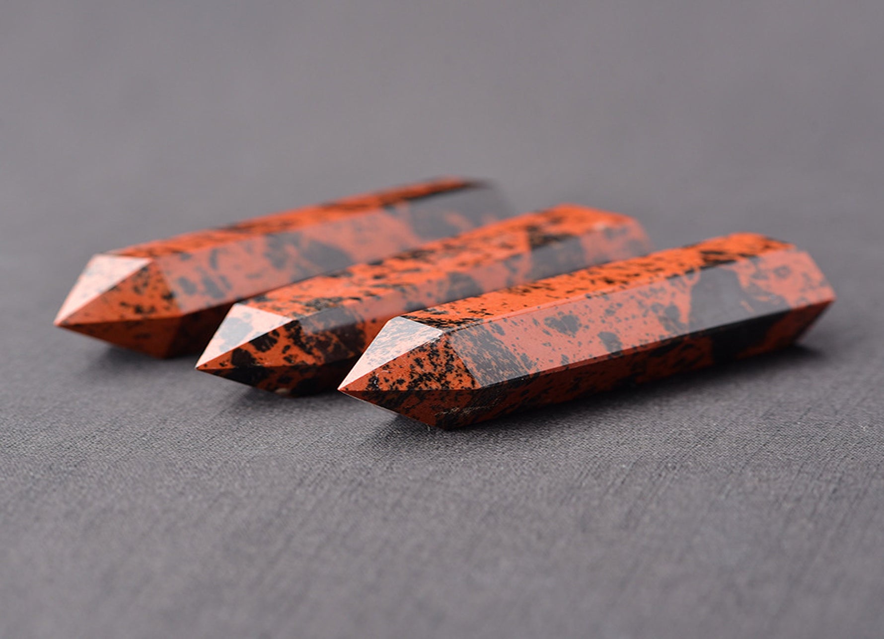 Mahogany Obsidian obelisk tower crystal with polished dark brown and black gemstone surface, decorative and energy-clearing stone.