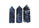 Sodalite obelisk tower crystal from GemstoneGO, featuring deep blue and white mineral patterns on a polished stone sculpture.
