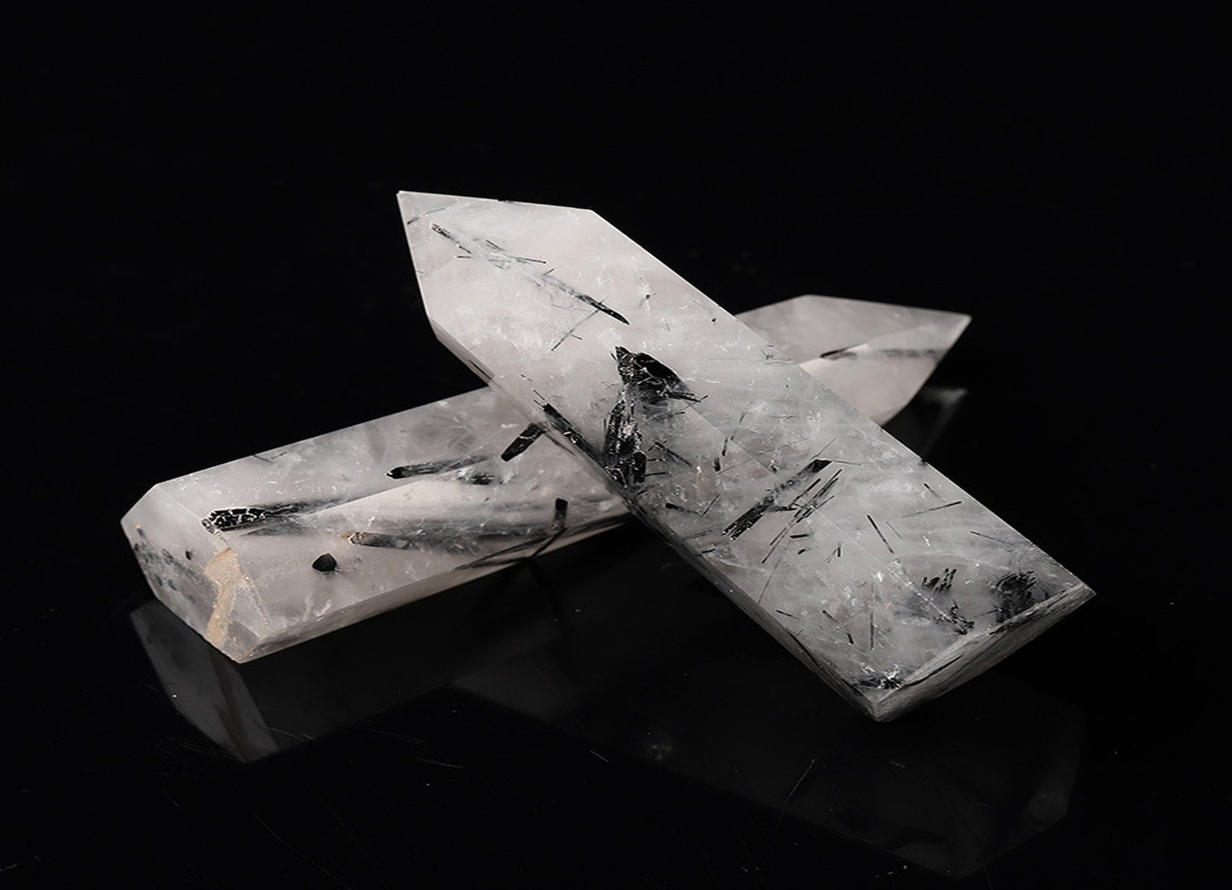 Tourmalinated Quartz obelisk tower crystal from GemstoneGO, featuring black tourmaline inclusions in clear quartz.