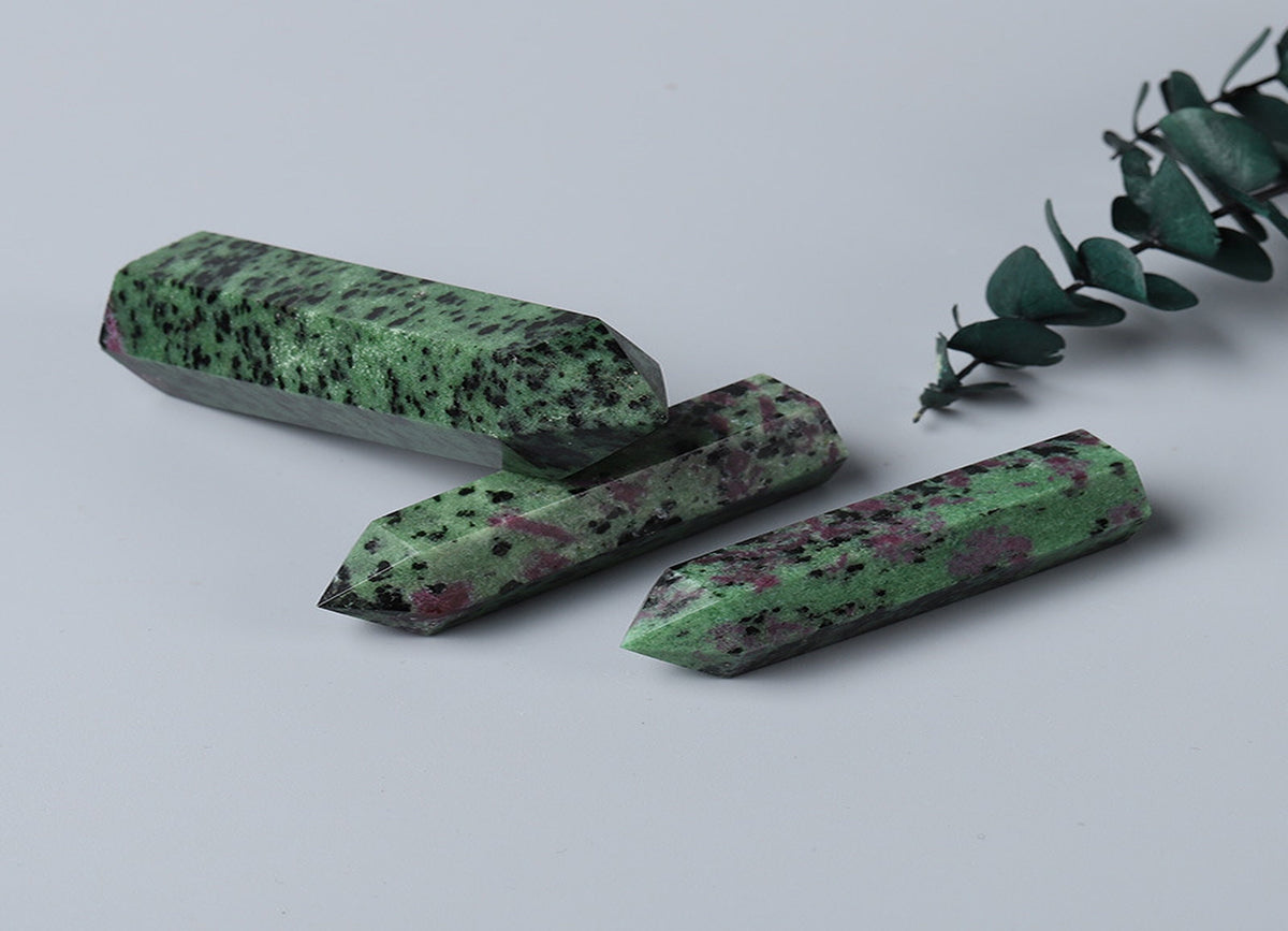 Ruby Zoisite obelisk tower crystal from GemstoneGO, showcasing vibrant red and green mineral patterns in a polished stone.