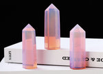 Pink Opalite obelisk tower crystal from GemstoneGO, showcasing a smooth, polished pink crystal with a pointed obelisk shape.