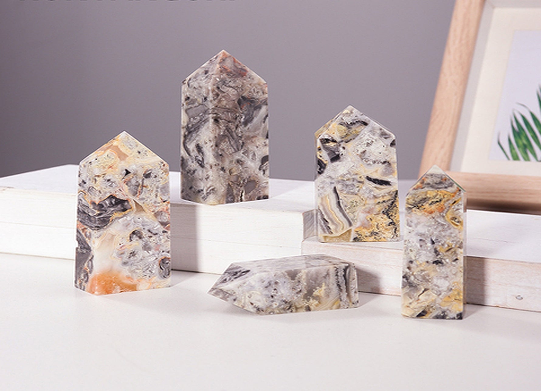 Crazy Lace Agate obelisk tower crystal from GemstoneGO featuring vibrant, intricate patterns and polished pointed shape.