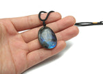 Labradorite crystal necklace on a cord with gemstone details, showcasing the polished stone and handcrafted design.