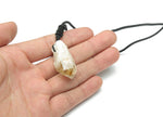 Citrine crystal pendant on a cord necklace from GemstoneGO, showcasing a polished yellow gemstone with a simple black cord.