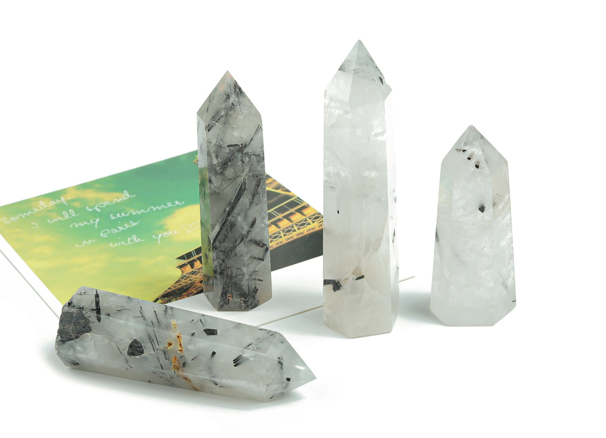 Tourmalinated Quartz obelisk crystal tower by GemstoneGO showcasing black tourmaline inclusions in clear quartz shape.