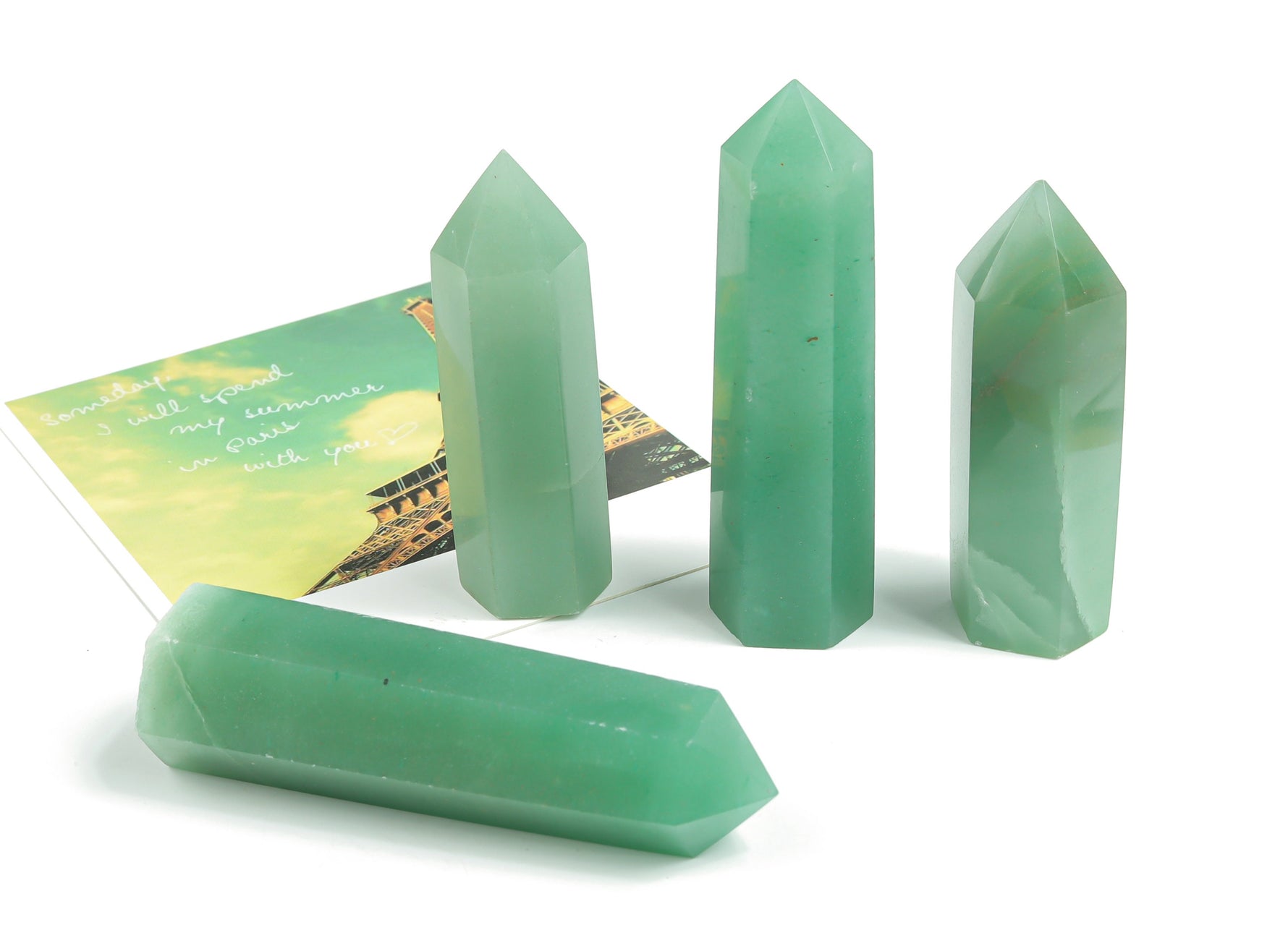Aventurine obelisk tower crystal from GemstoneGO, polished green gemstone with natural striations and pointed top design.