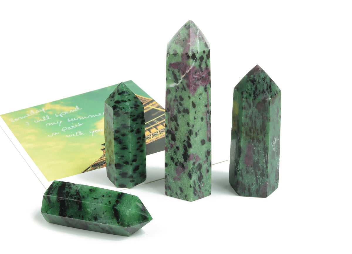Ruby Zoisite obelisk tower crystal from GemstoneGO, showcasing vibrant red and green mineral patterns on a polished stone.