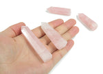 Rose quartz obelisk crystal tower from GemstoneGO, featuring a polished pink gemstone with natural veining and a pointed top.