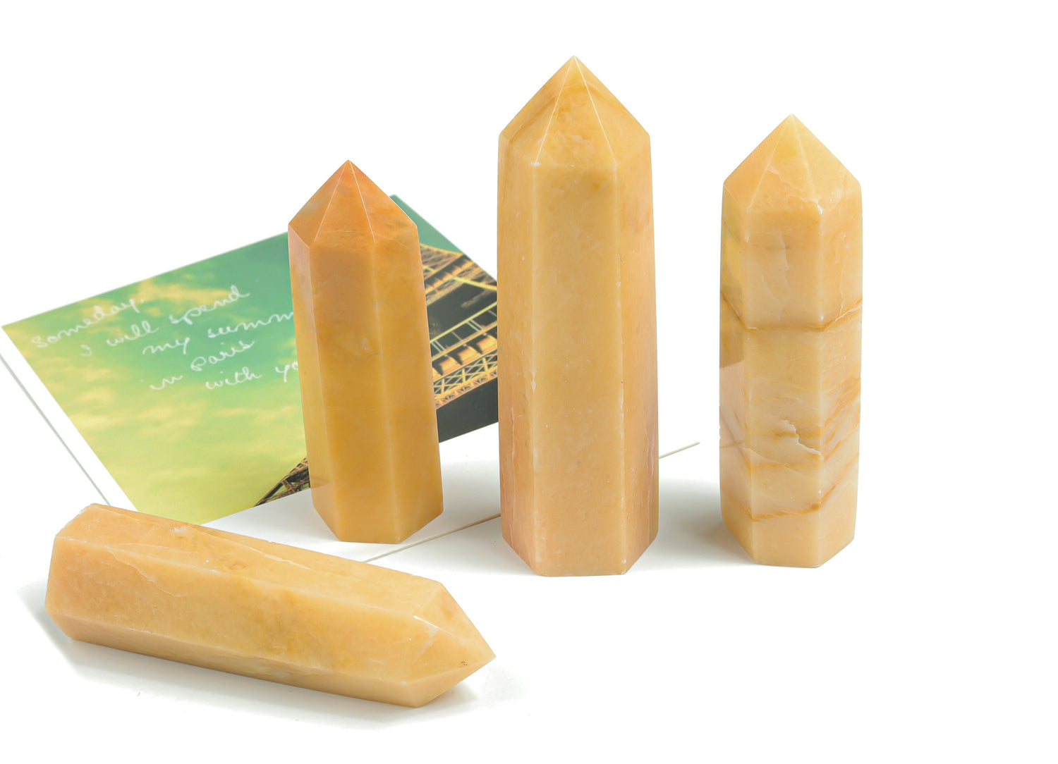 Yellow aventurine obelisk tower crystal from GemstoneGO, showing a polished yellow gemstone with natural veining and a pointed top.