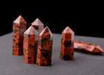 Mahogany Obsidian obelisk tower crystal from GemstoneGO, showcasing a polished dark brown and black stone with natural patterns.