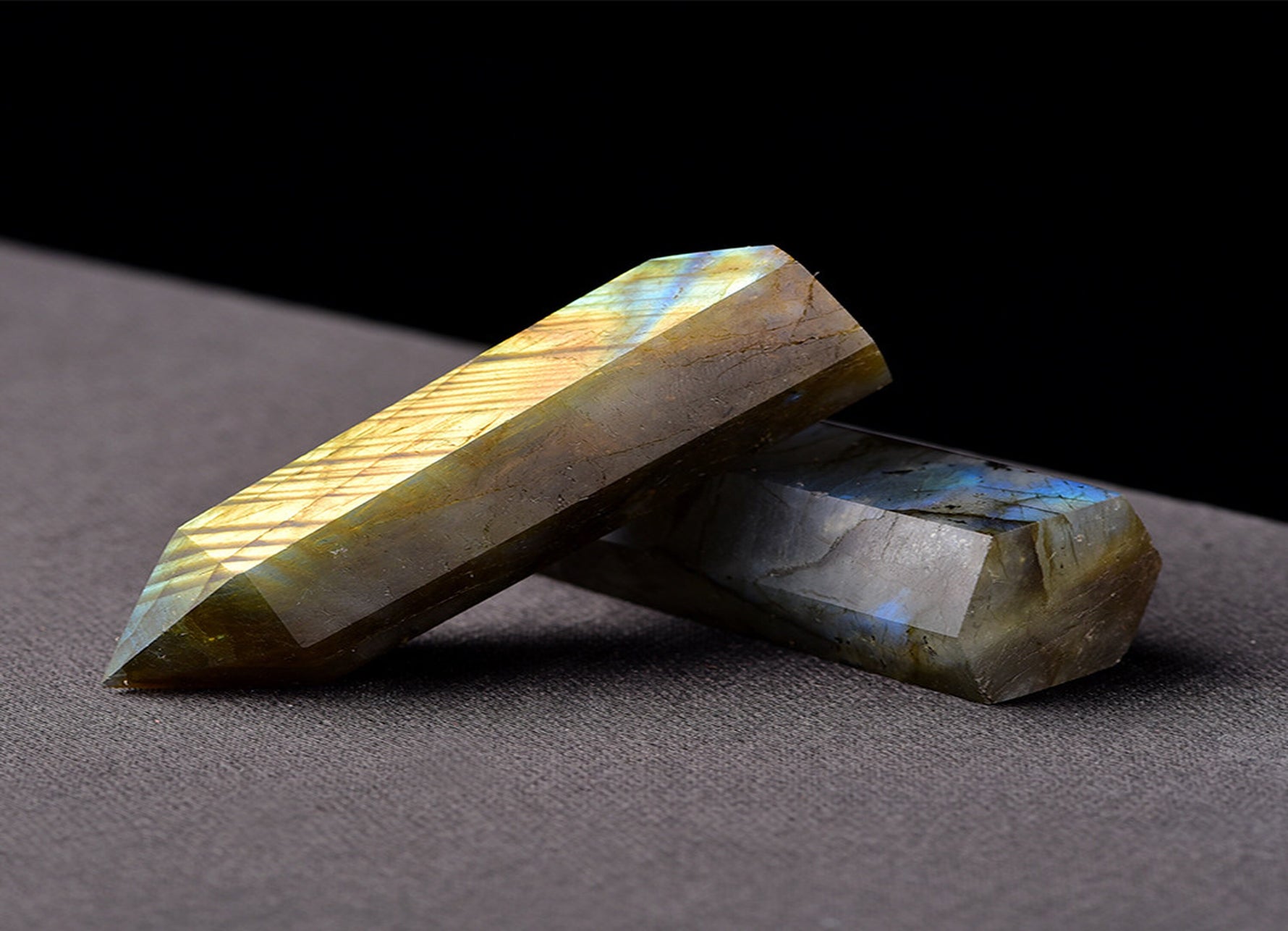 Labradorite obelisk tower crystal from GemstoneGO with iridescent flashes and natural stone texture, standing tall and polished.