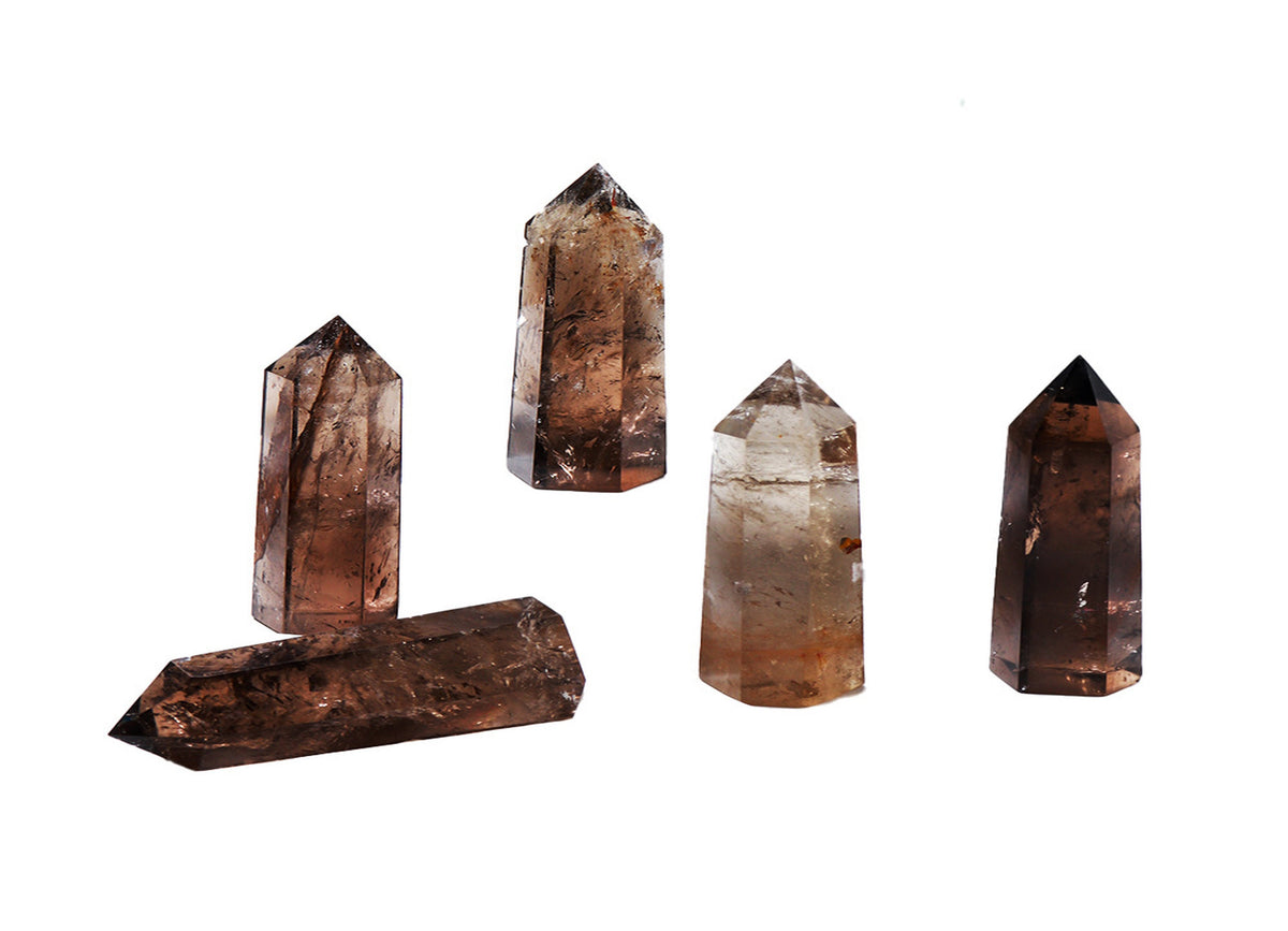 Smoky Quartz obelisk tower crystal from GemstoneGO, featuring a polished, dark brown and gray stone with a pointed top.