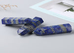 Lapis Lazuli obelisk tower crystal from GemstoneGO, showcasing deep blue stone with golden pyrite inclusions on a white background.
