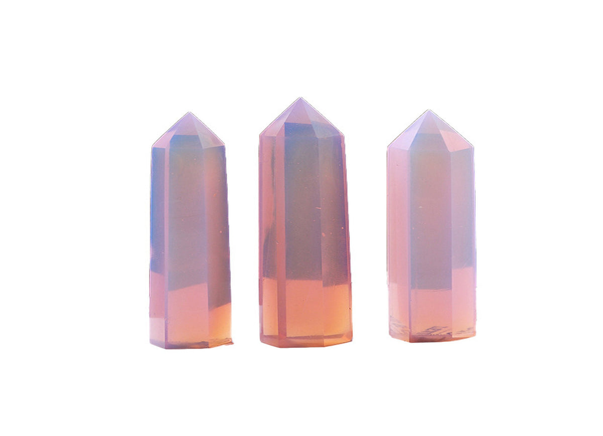 Pink Opalite obelisk tower crystal from GemstoneGO, showcasing a smooth, pink and iridescent gemstone with a pointed obelisk shape.