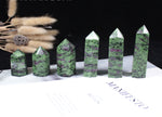 Ruby Zoisite obelisk tower crystal from GemstoneGO featuring vibrant red and green mineral patterns on a polished stone.