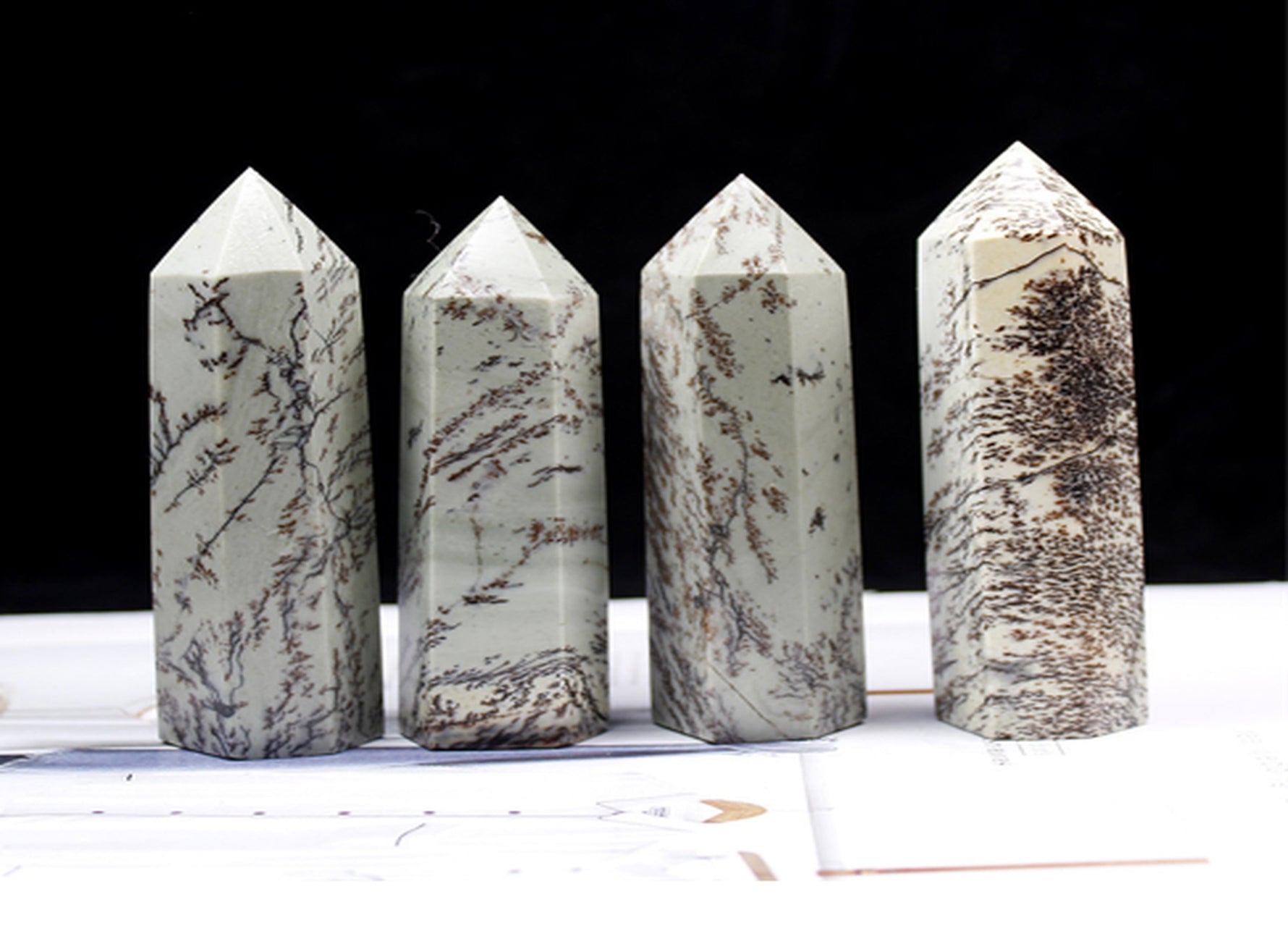 Dendritic Jade obelisk tower crystal from GemstoneGO, showcasing natural green and brown patterns on a polished stone.