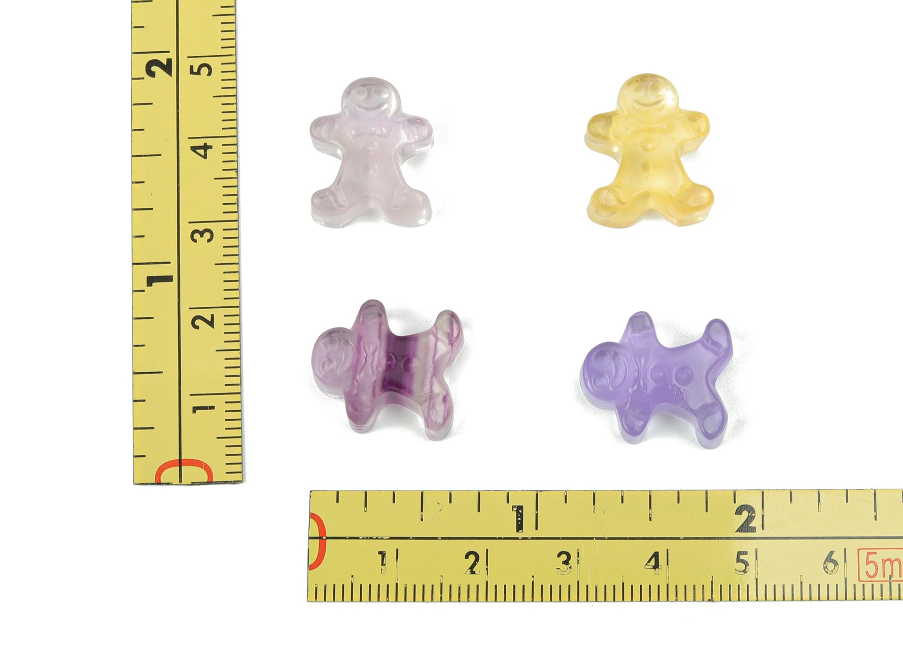 Fluorite gingerbread cookies carving gemstone from GemstoneGO, showcasing vibrant green and purple hues with detailed carving.