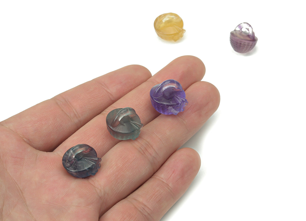 Fluorite garden basket carving gemstone by GemstoneGO, featuring intricate floral design and vibrant green and purple hues.