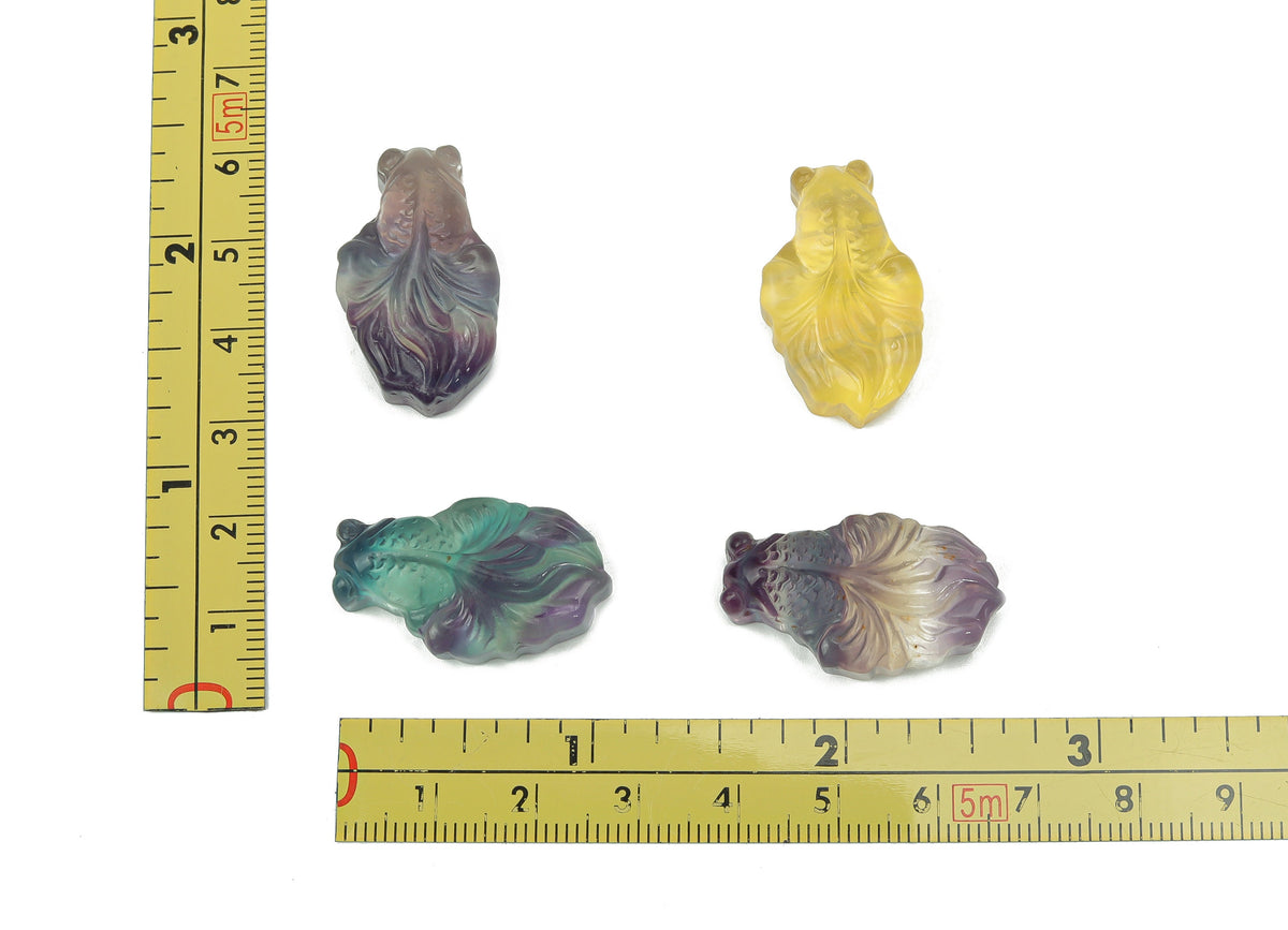 Colorful fluorite gemstone carved into an aquarium fish shape, showcasing vibrant hues and intricate detailing by GemstoneGO.