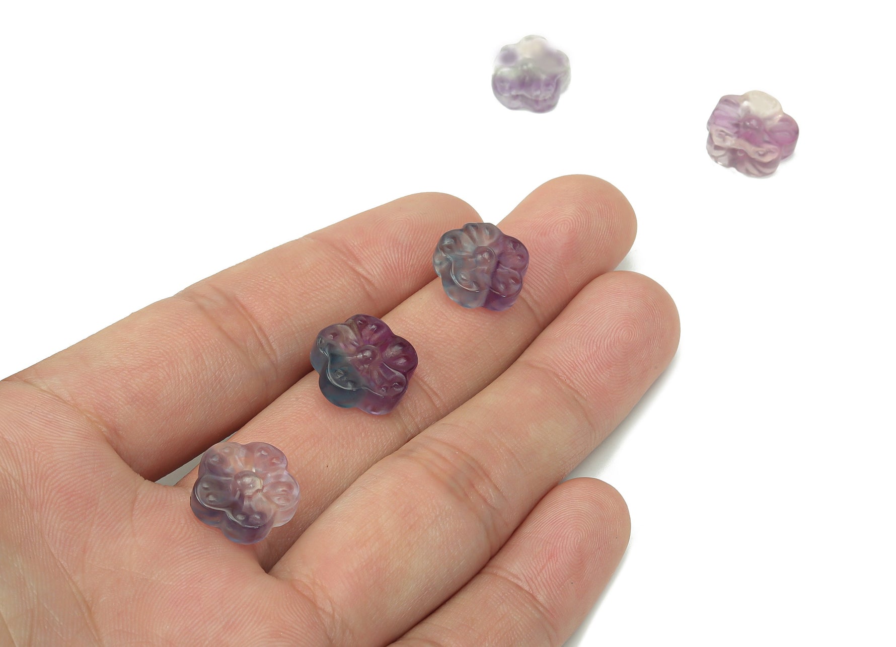 Mini fluorite flower carving gemstone by GemstoneGO, showing a colorful, detailed floral design on a small polished mineral piece.