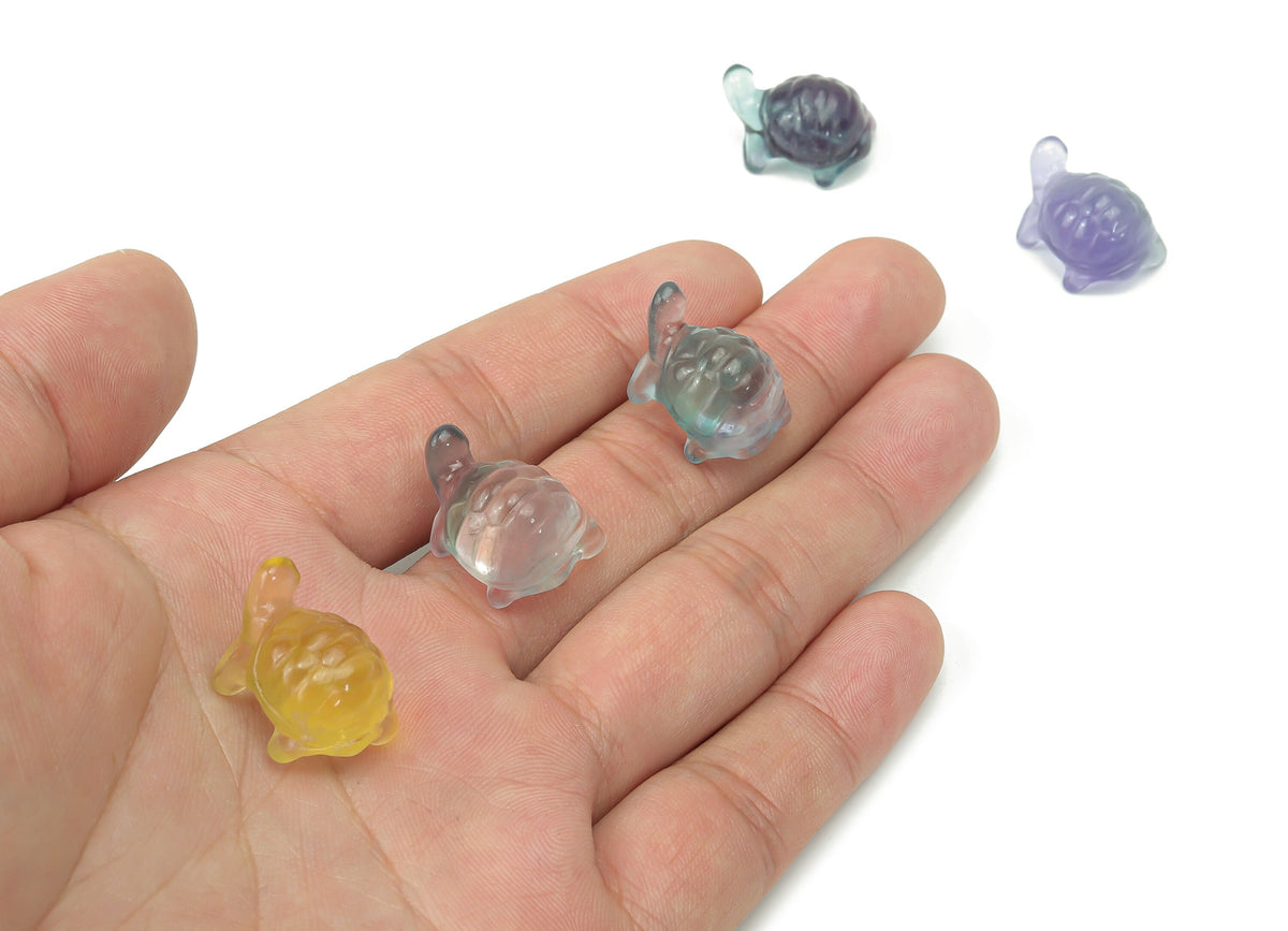 Mini fluorite turtle gemstone carving by GemstoneGO, showcasing vibrant purple and green hues on a smooth polished surface.