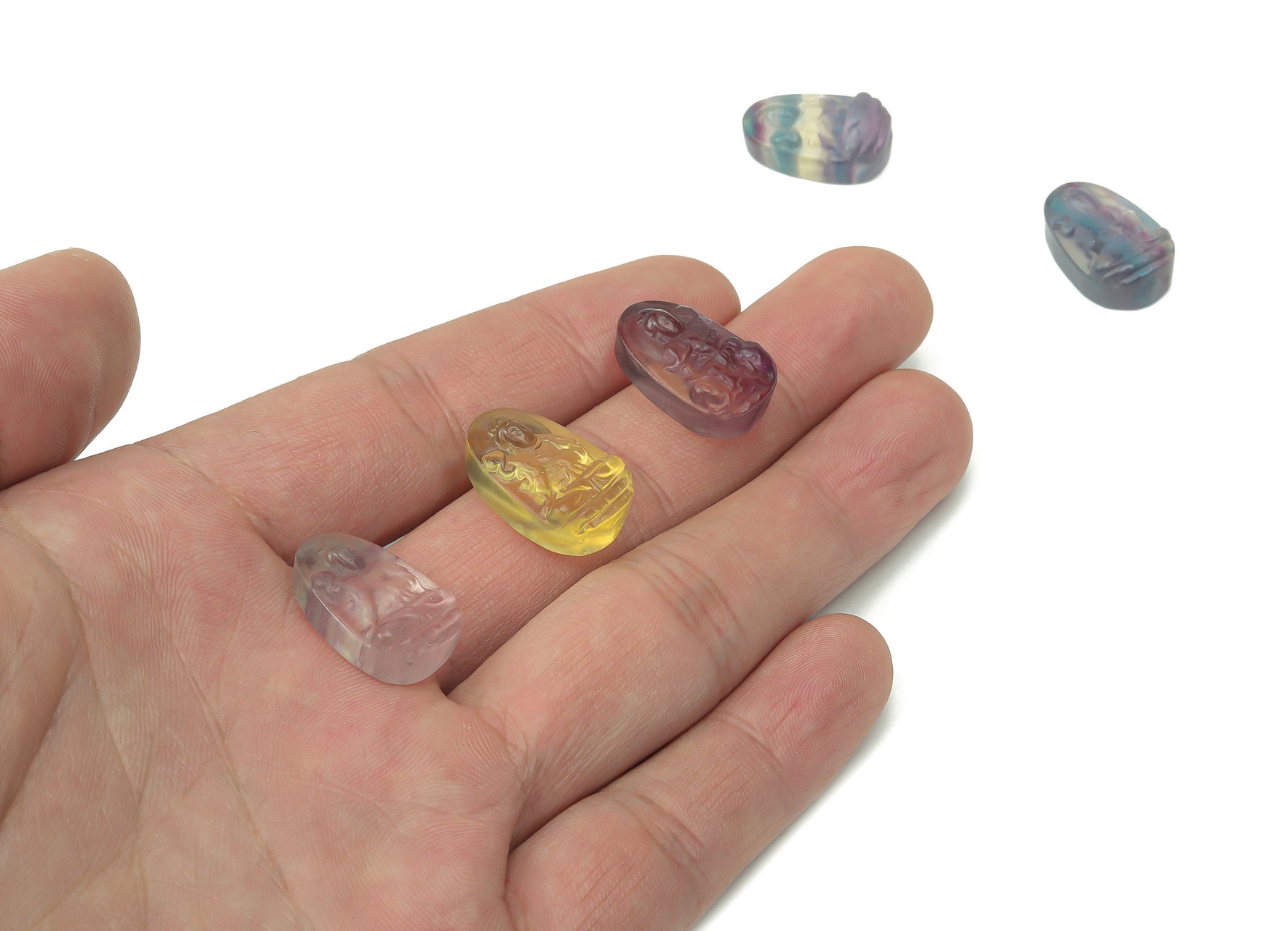 Mini Fluorite Buddha carving gemstone from GemstoneGO, detailed stone sculpture with vibrant green and purple hues.