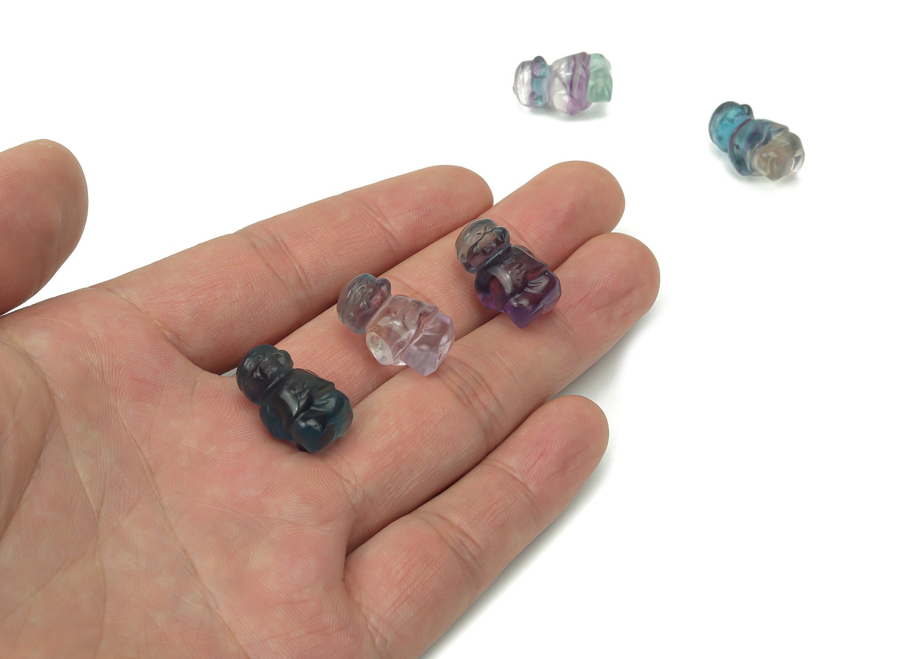 Small fluorite mini crystal carving gemstone by GemstoneGO, showcasing vibrant purple and green layered patterns.