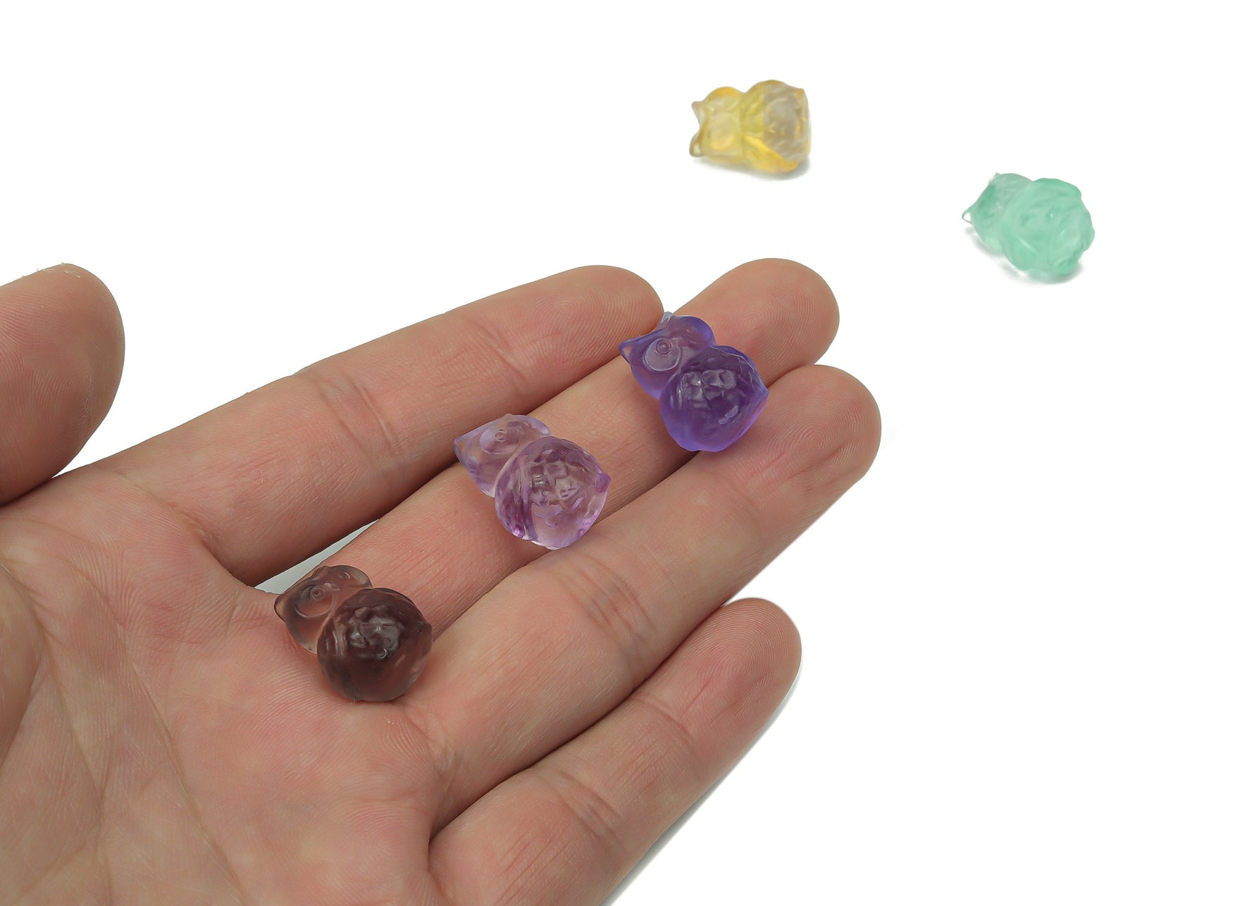 Fluorite owl carving gemstone from GemstoneGO showcasing vibrant purple and green hues with detailed owl features.