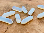 Opalite terminated carved point gemstone, 33mm, from GemstoneGO, showcasing smooth, polished surface with natural stone patterns.