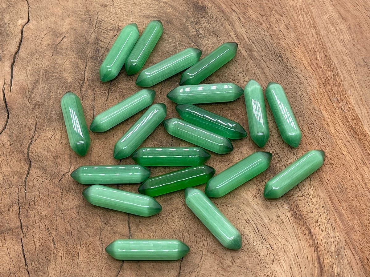 Green Cats Eye gemstone carved point, 33mm, with a polished termination, showcasing vibrant green color and eye-catching chatoyancy.