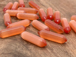 Orange Cats Eye gemstone carved point, 33mm, with vibrant orange color and cat's eye shimmer, from GemstoneGO.