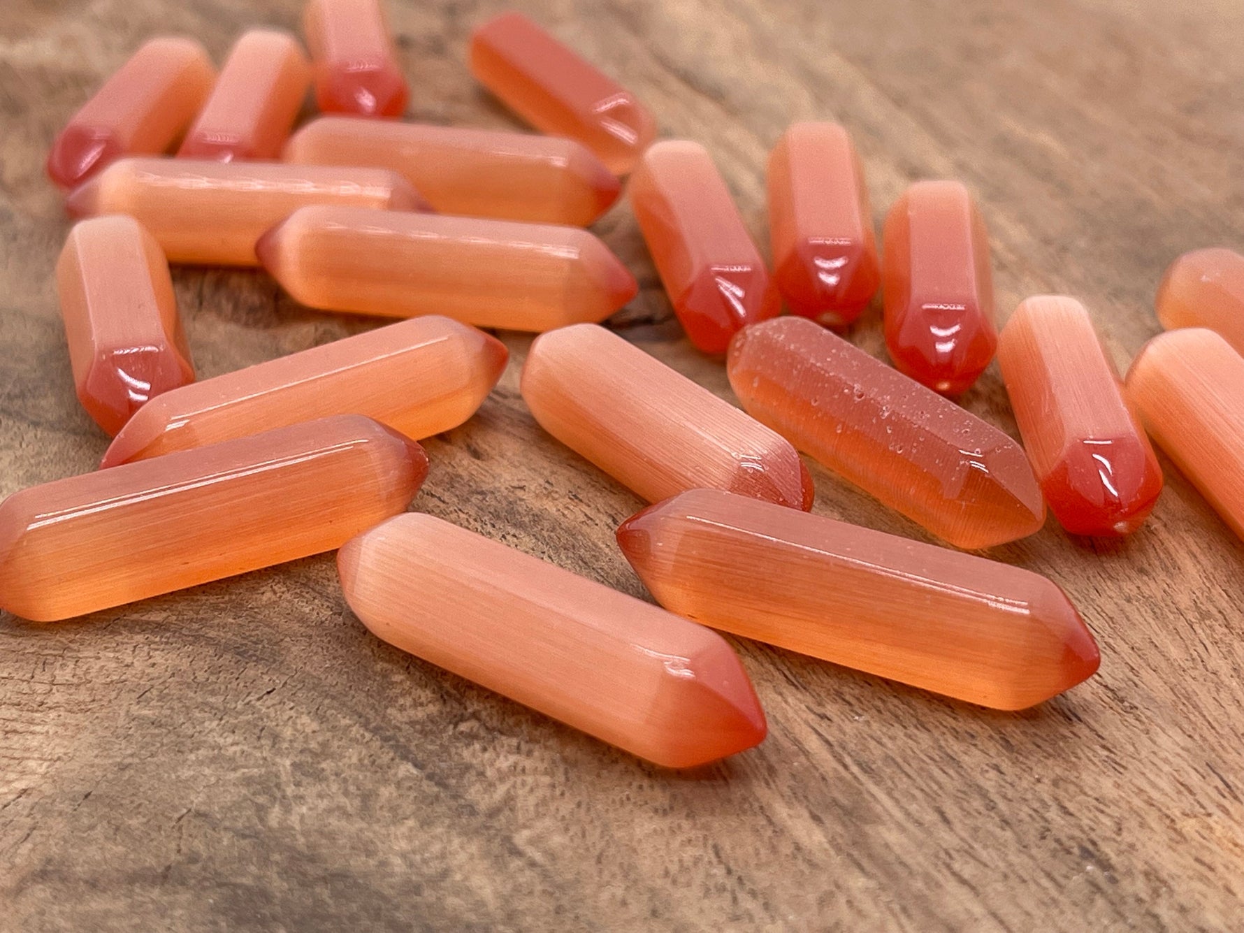 Orange Cats Eye gemstone carved point, 33mm, with vibrant orange color and cat's eye shimmer, from GemstoneGO.