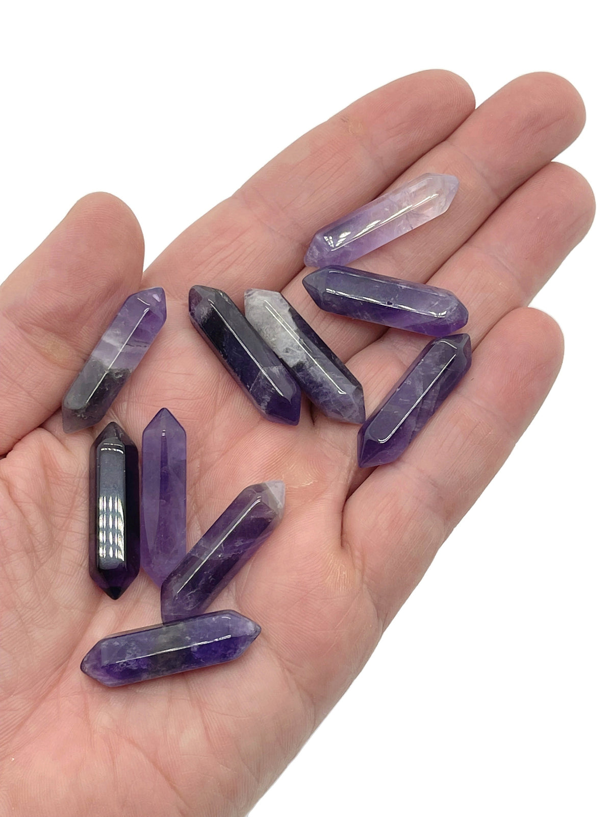 Amethyst terminated carved point gemstone, 33mm, with purple crystal structure and polished faceted surface from GemstoneGO.